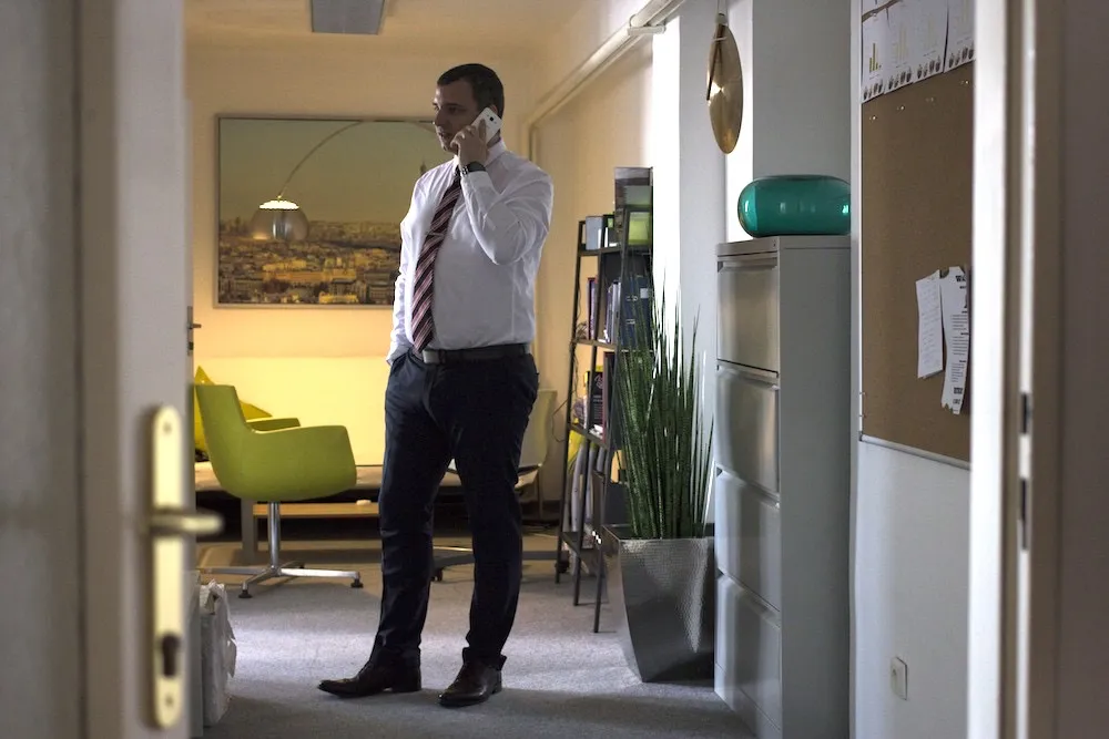 Infinity Vision team member taking a phone call in the office